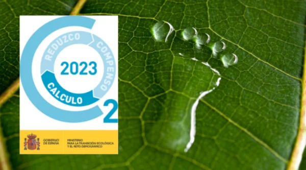 Registro huella de carbono 2023 – sello oficial MITECO sobre hoja verde con huella de agua